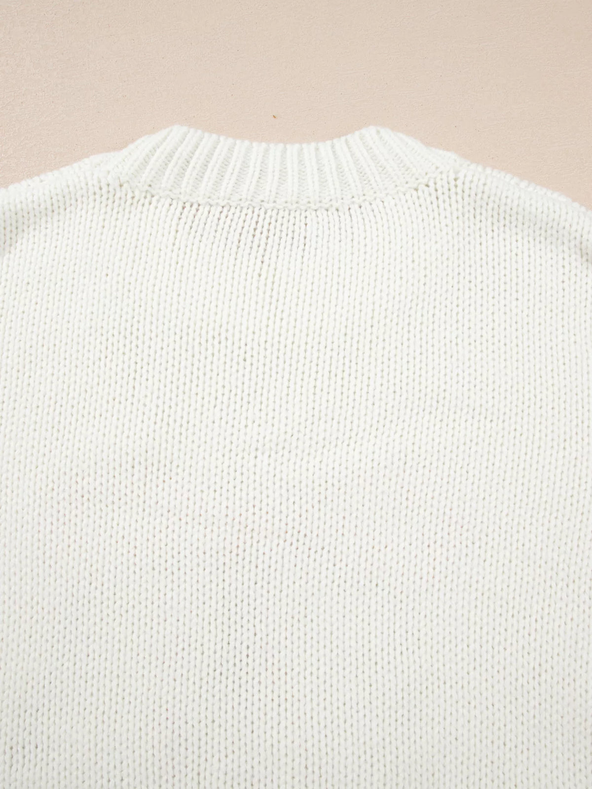 White sweater close-up from back with ribbed crew neckline