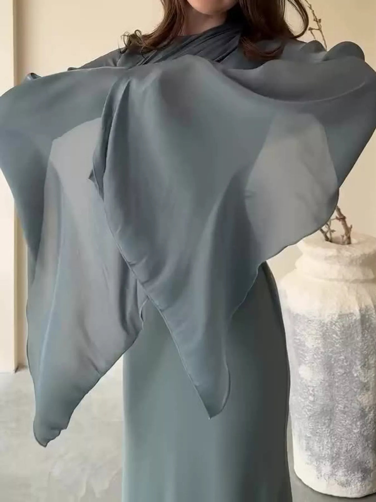Dark gray maxi dress showing the sheer, flowing sleeve fabric