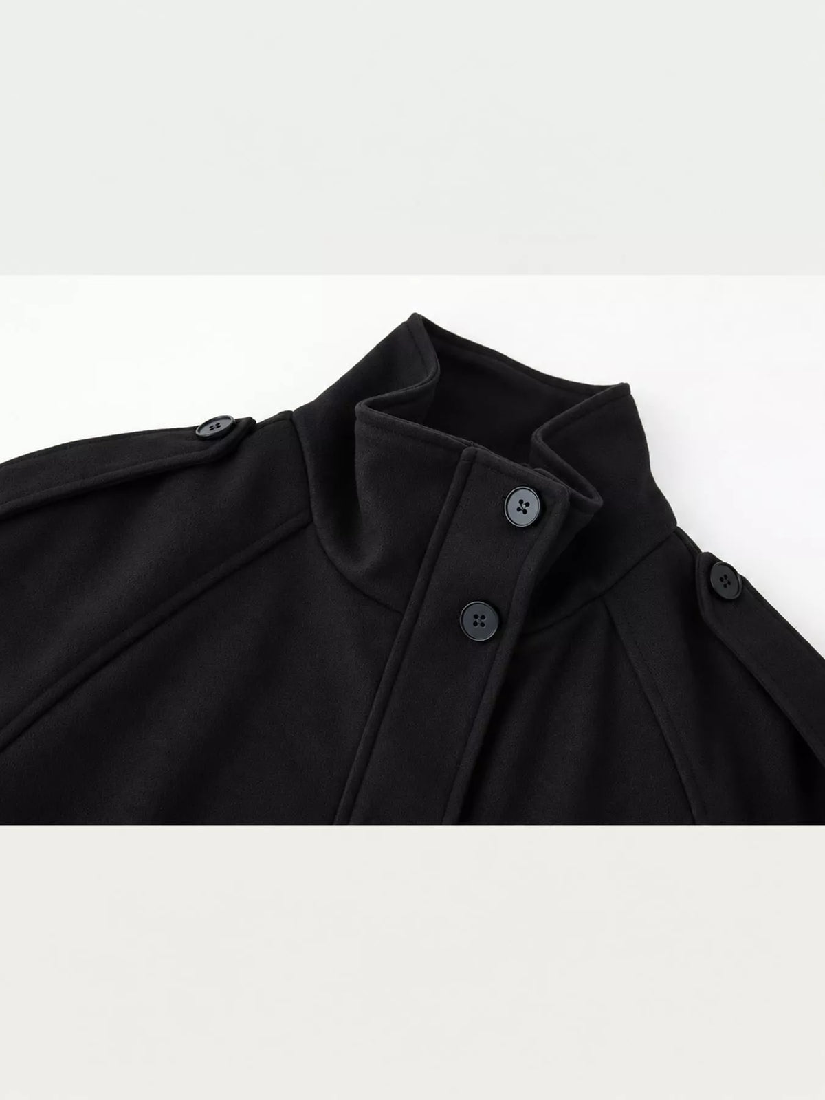 Black stand-collar zip-up jacket close-up with inner button placket and stand collar.