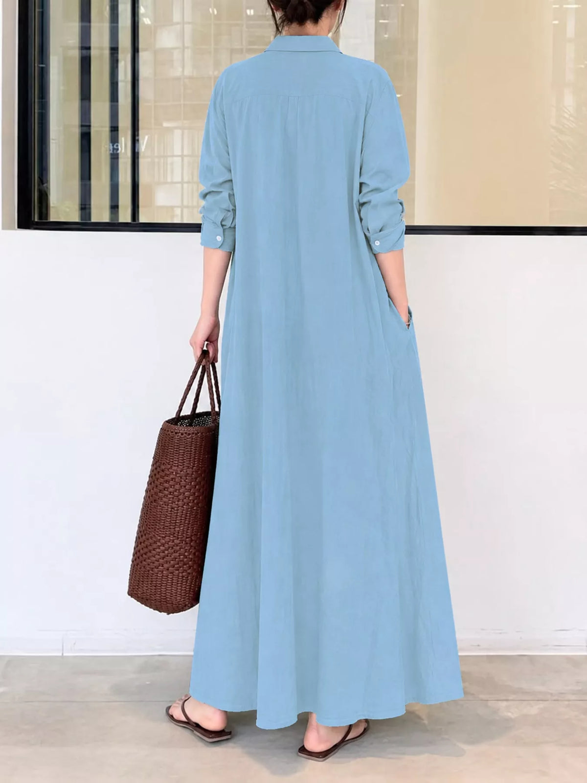 Light blue button-front maxi shirt dress from back, long sleeves and full gathered skirt