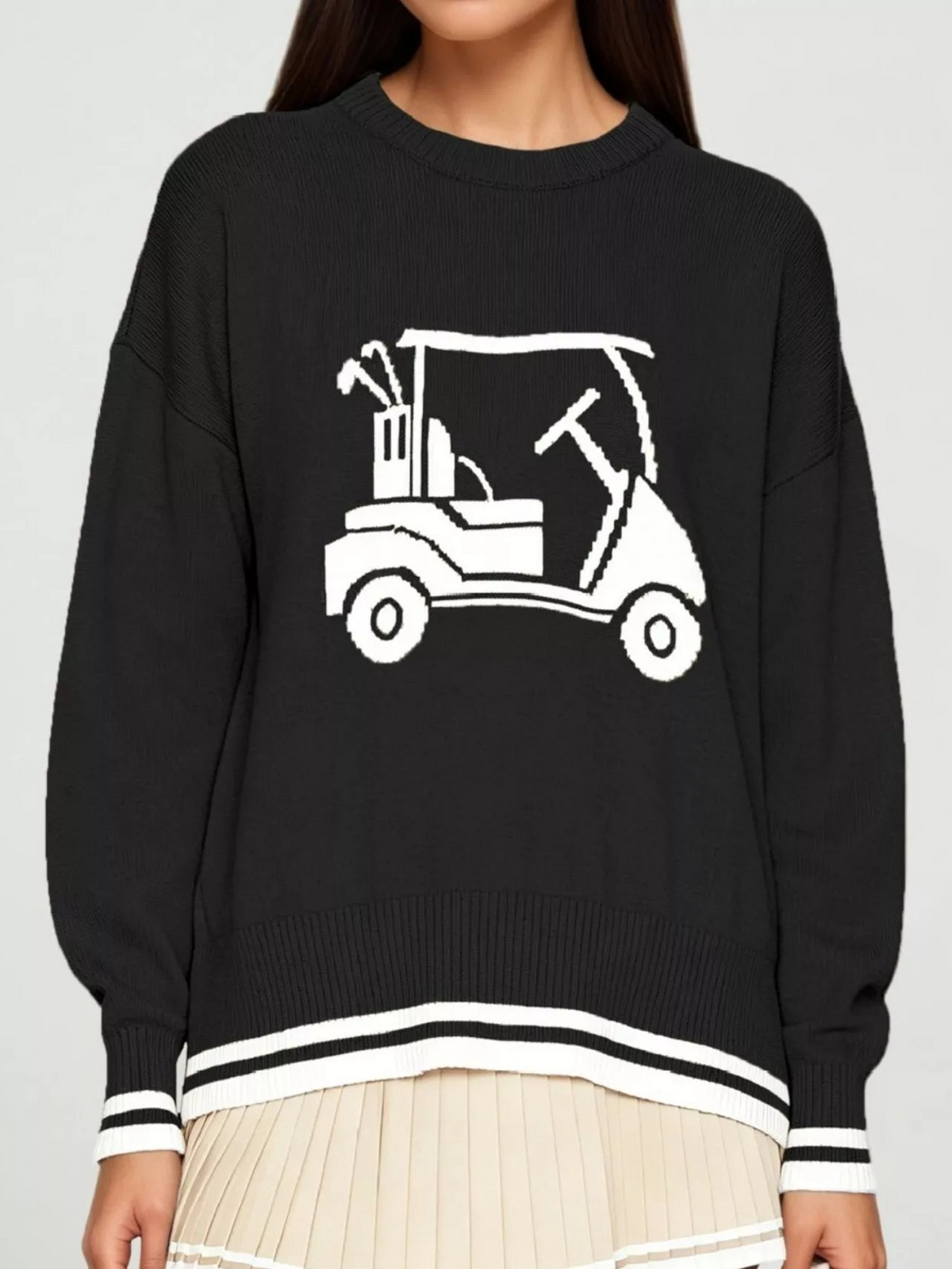 Black golf cart graphic sweater with ribbed cuffs and crew neck; white striped hem