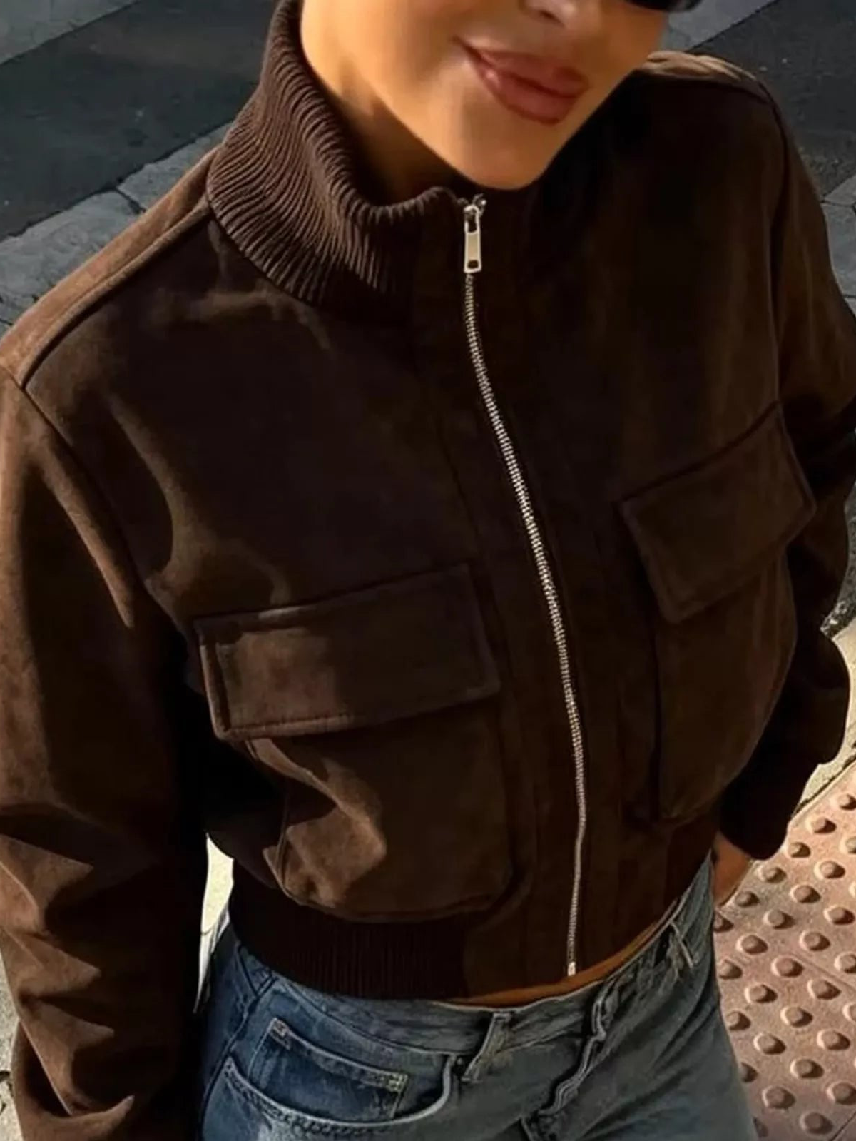 Dark brown zip-up jacket with ribbed mock neck, front zipper, and two flap chest pockets