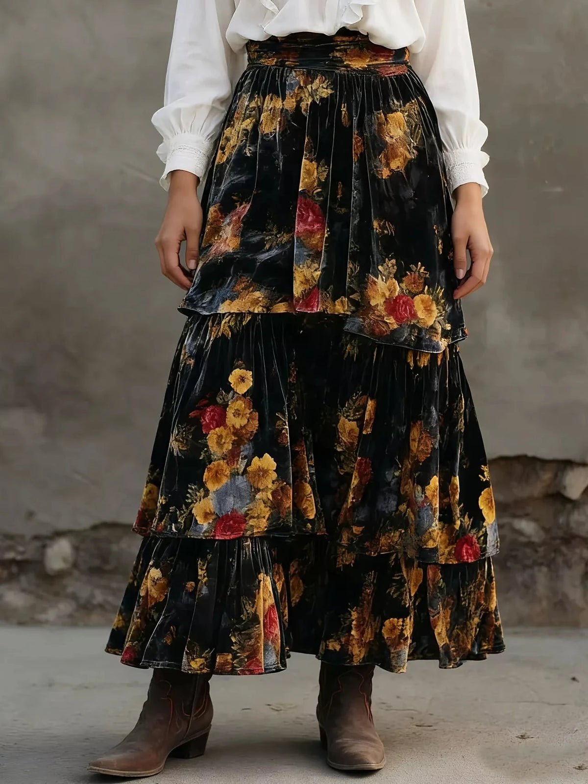 Tiered floral maxi skirt on black fabric, elastic waistband, ruffled tiers with blooms