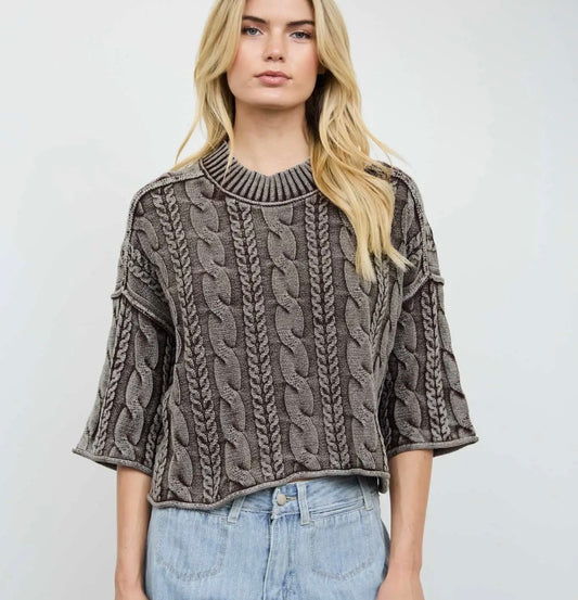 Cable-knit turtleneck pullover with 3/4 sleeves, ribbed collar and textured cable design