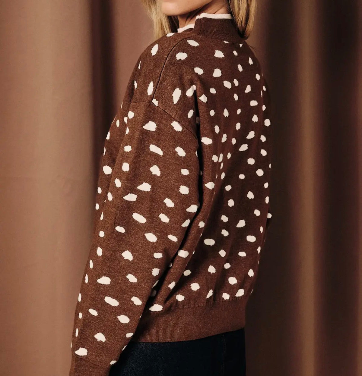 Dark brown mock-neck sweater with white dot pattern and deer graphic, long sleeves