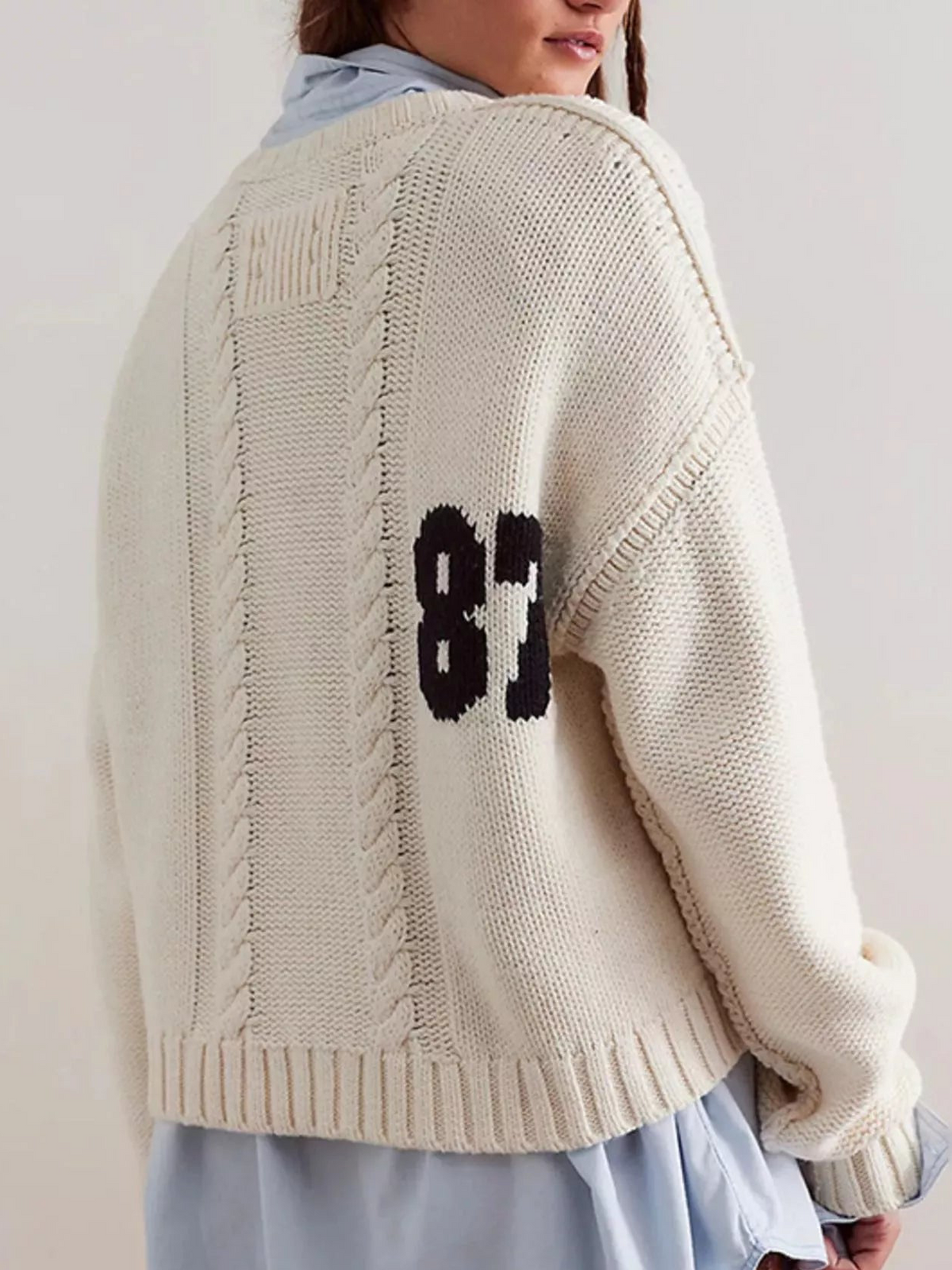 Off-white cable-knit sweater with black 87 number graphic on back