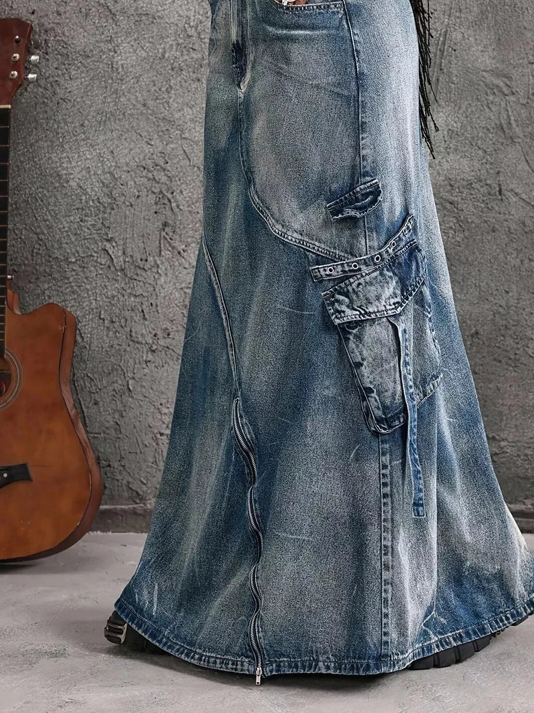 Blue high-waisted denim maxi skirt with long front zipper slit and cargo-style patch pockets
