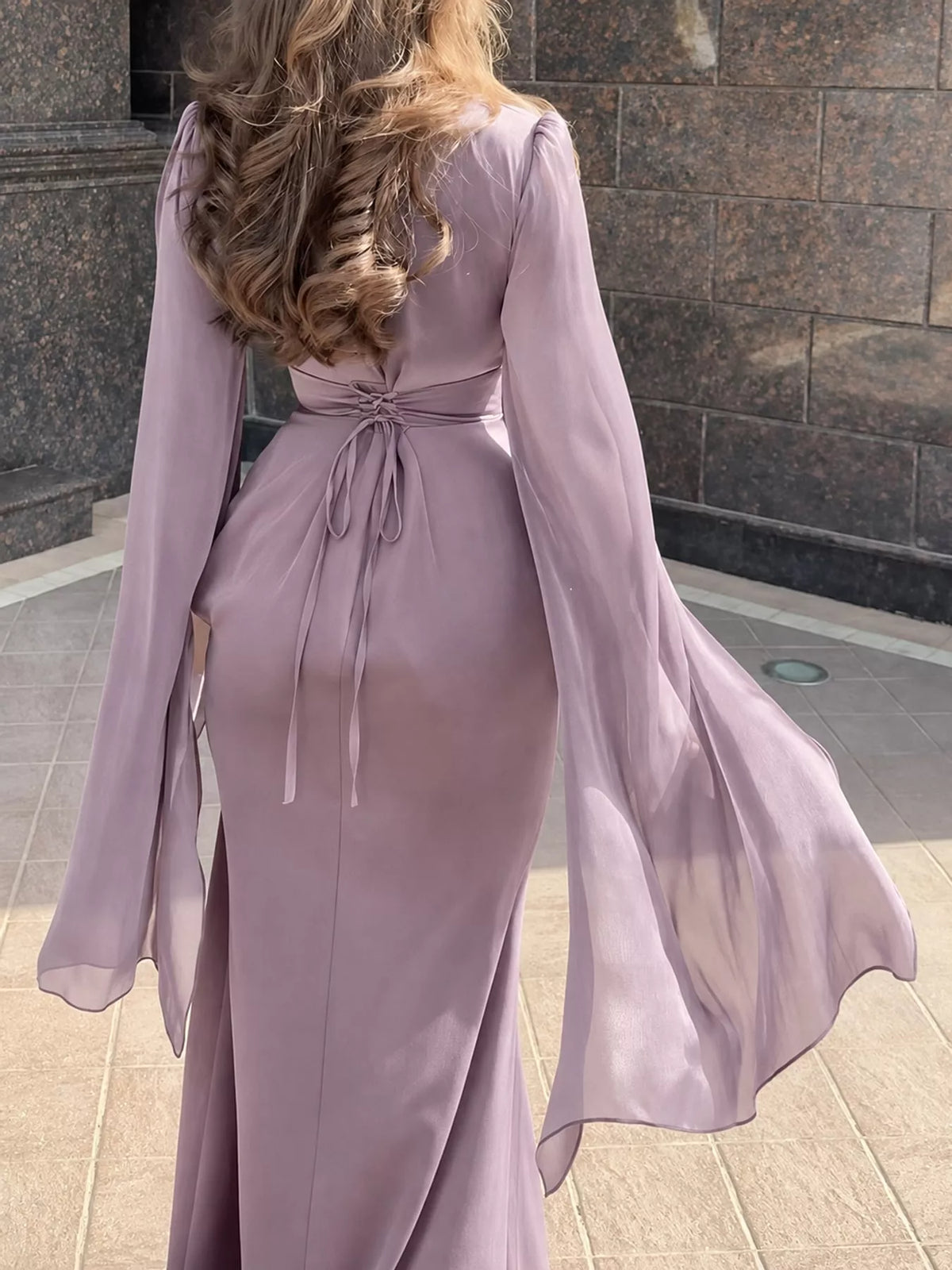 Mauve maxi dress, back view, with waist ties and long sheer flared sleeves