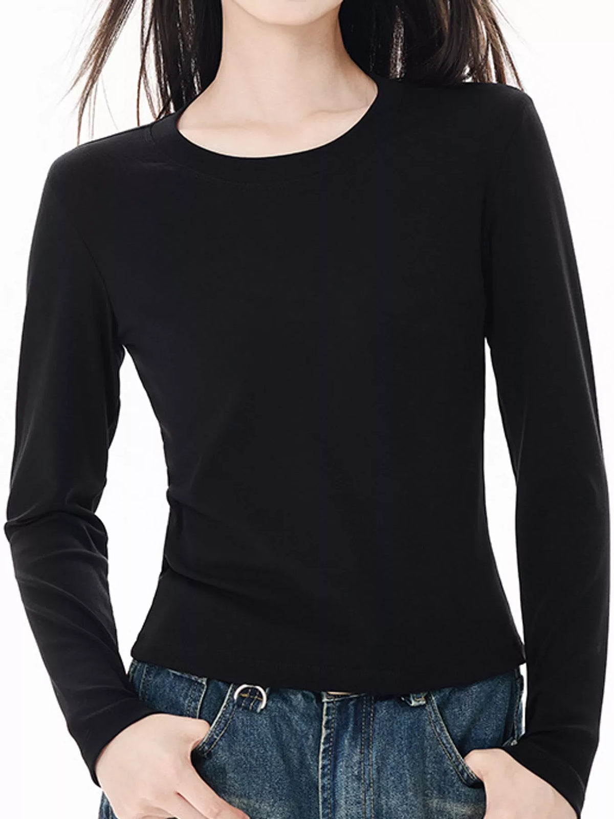 Black slim-fit long sleeve crew neck T-shirt on model with straight hemline.