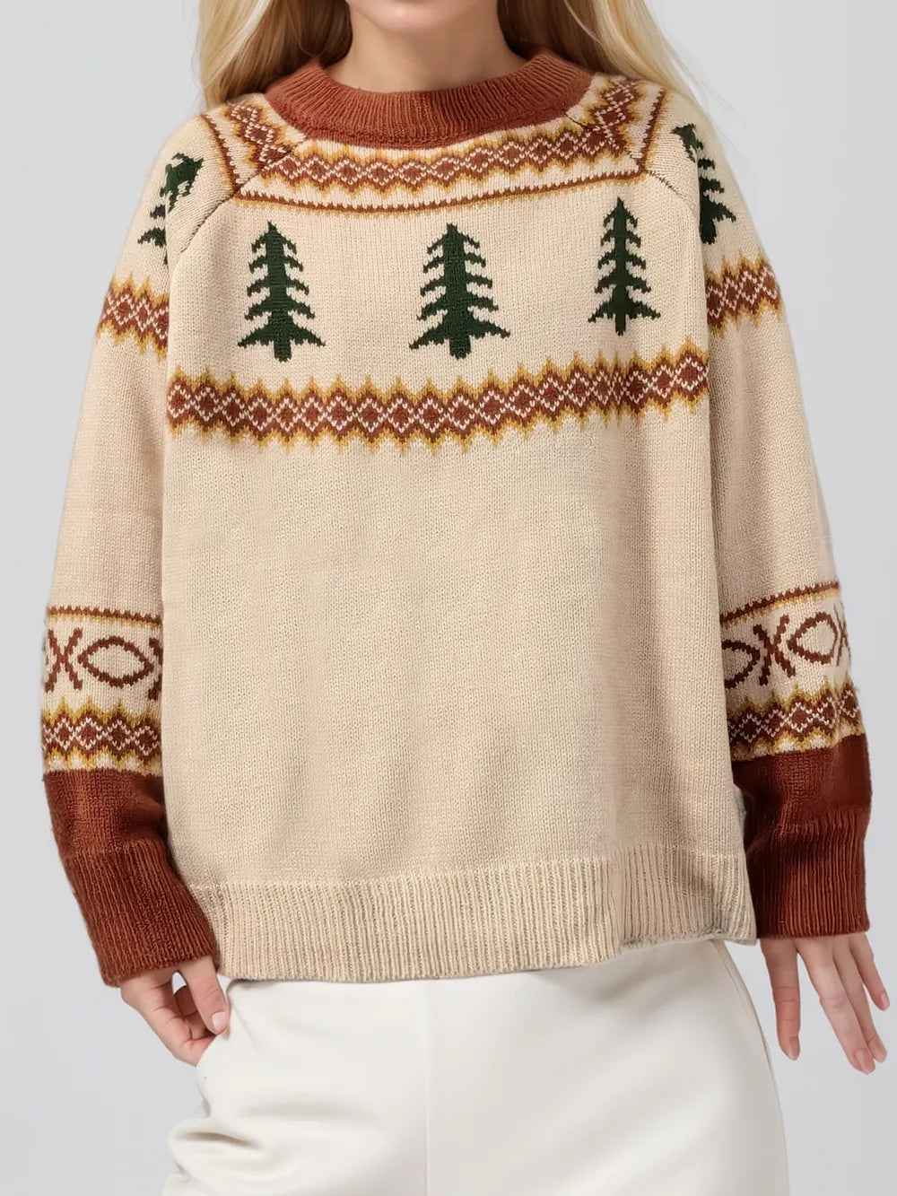 Tan knit sweater with green tree graphic, brown geometric trim at sleeves