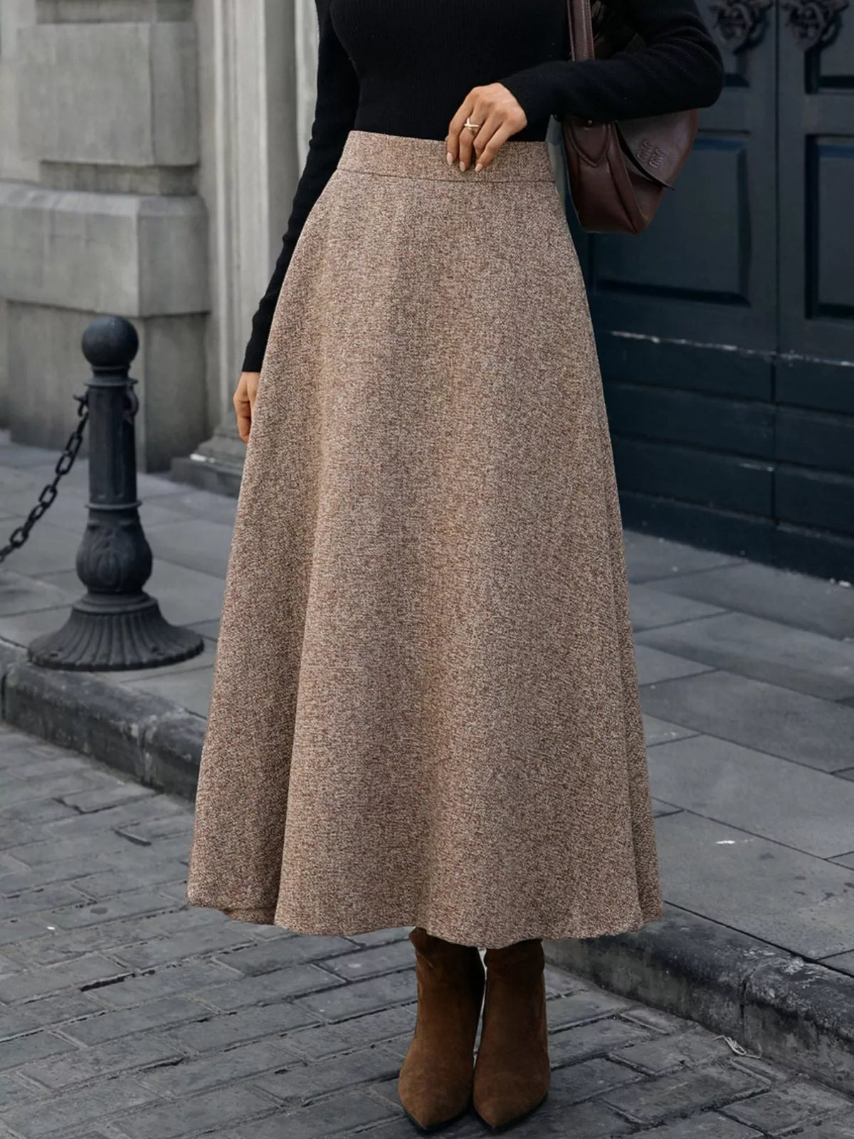 Brown A-line midi skirt shown from the front with a wide, flowing hem