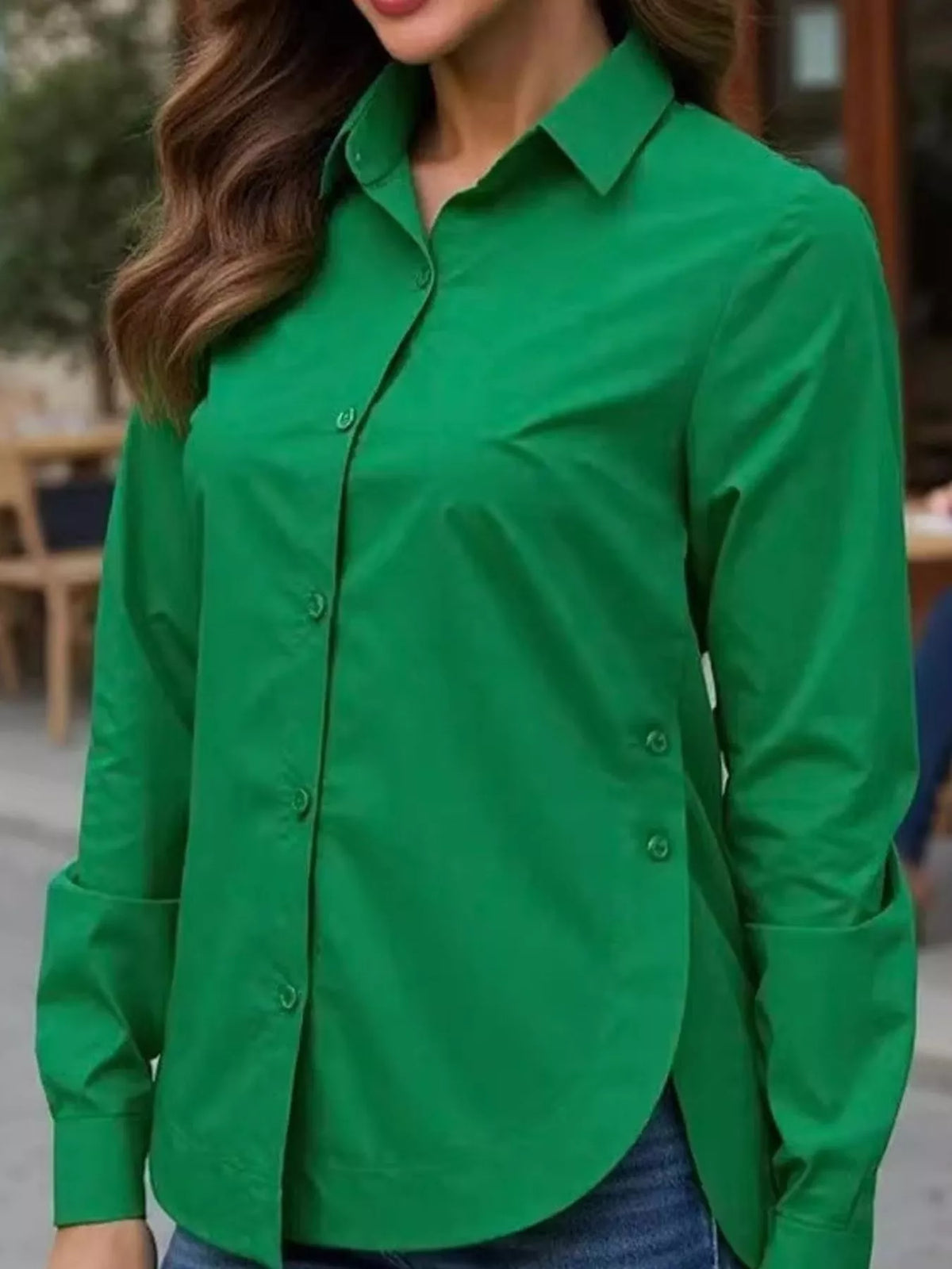 Green long-sleeve button-up shirt with pointed collar and button front.