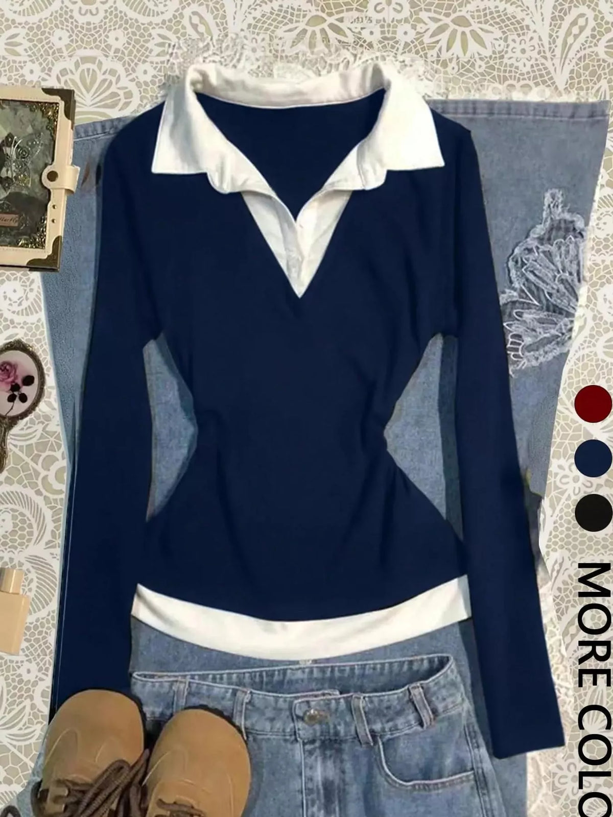 Dark blue long-sleeve shirt with white contrast collar and hem, V-neck, and fitted waist