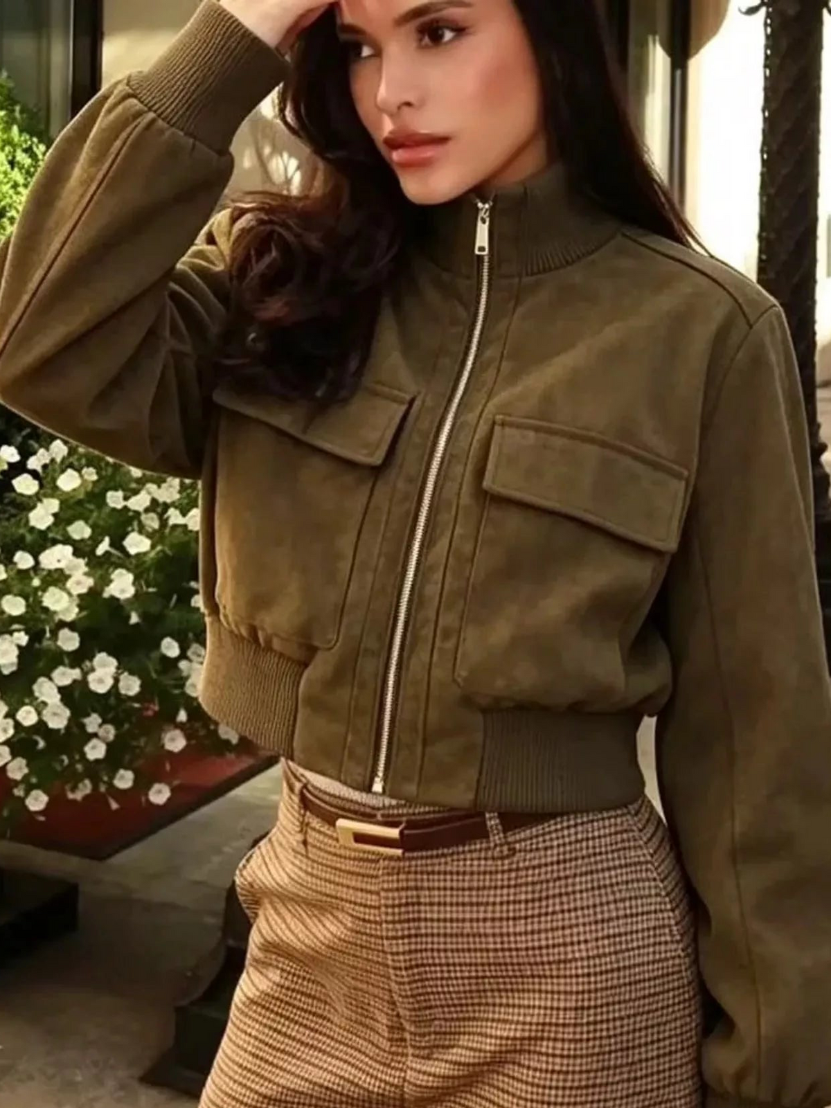 Olive green zip-up jacket with ribbed stand collar, front zipper, and chest flap pockets