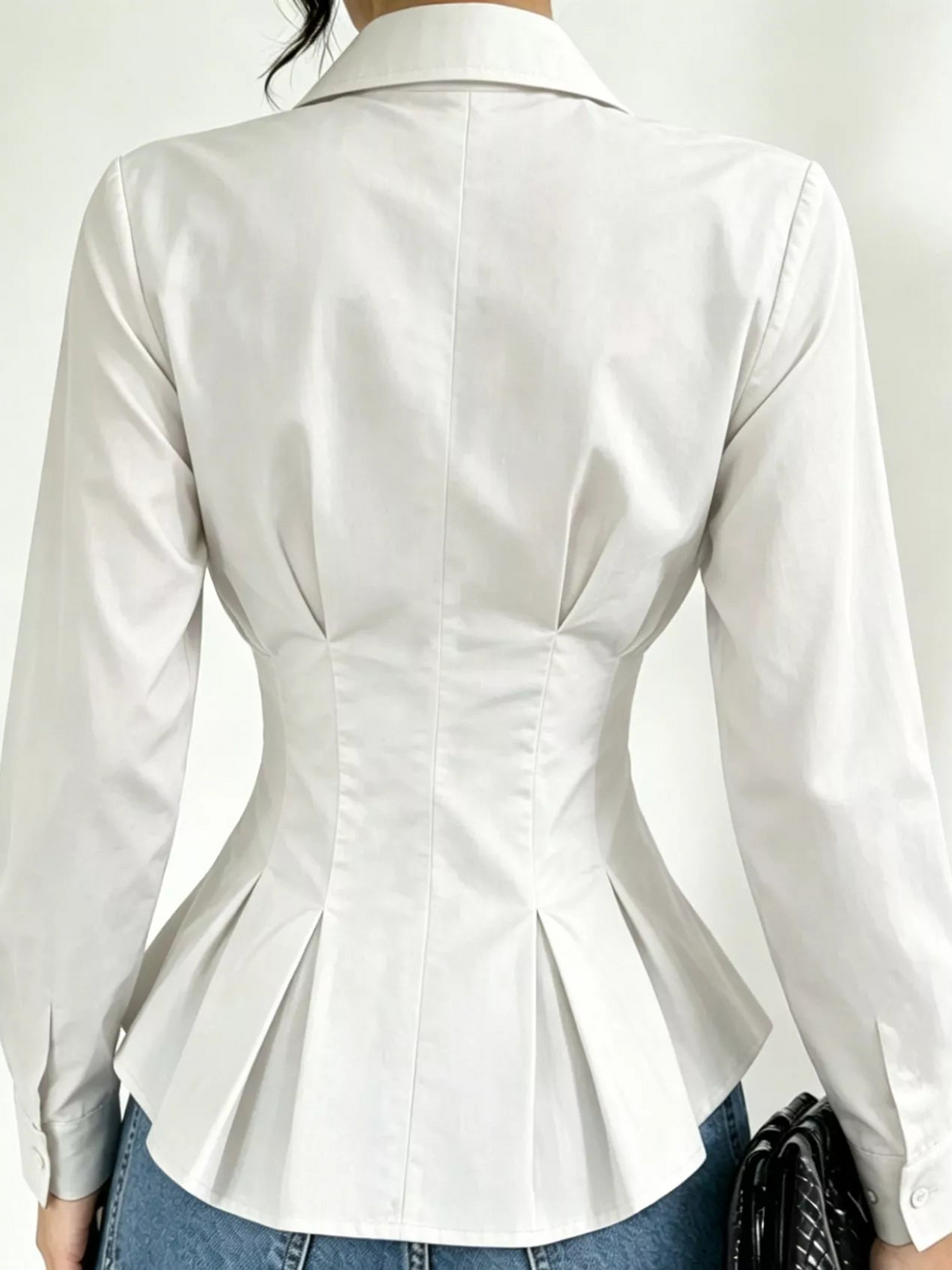 White button-down peplum blouse with fitted waist, back view, long sleeves
