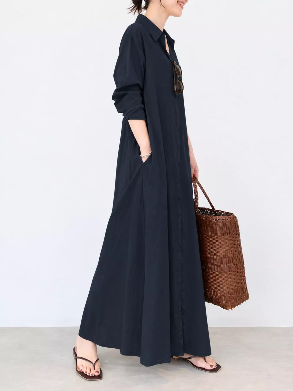Black button-front maxi shirt dress side view, long skirt with gathered flare and cuffed sleeves
