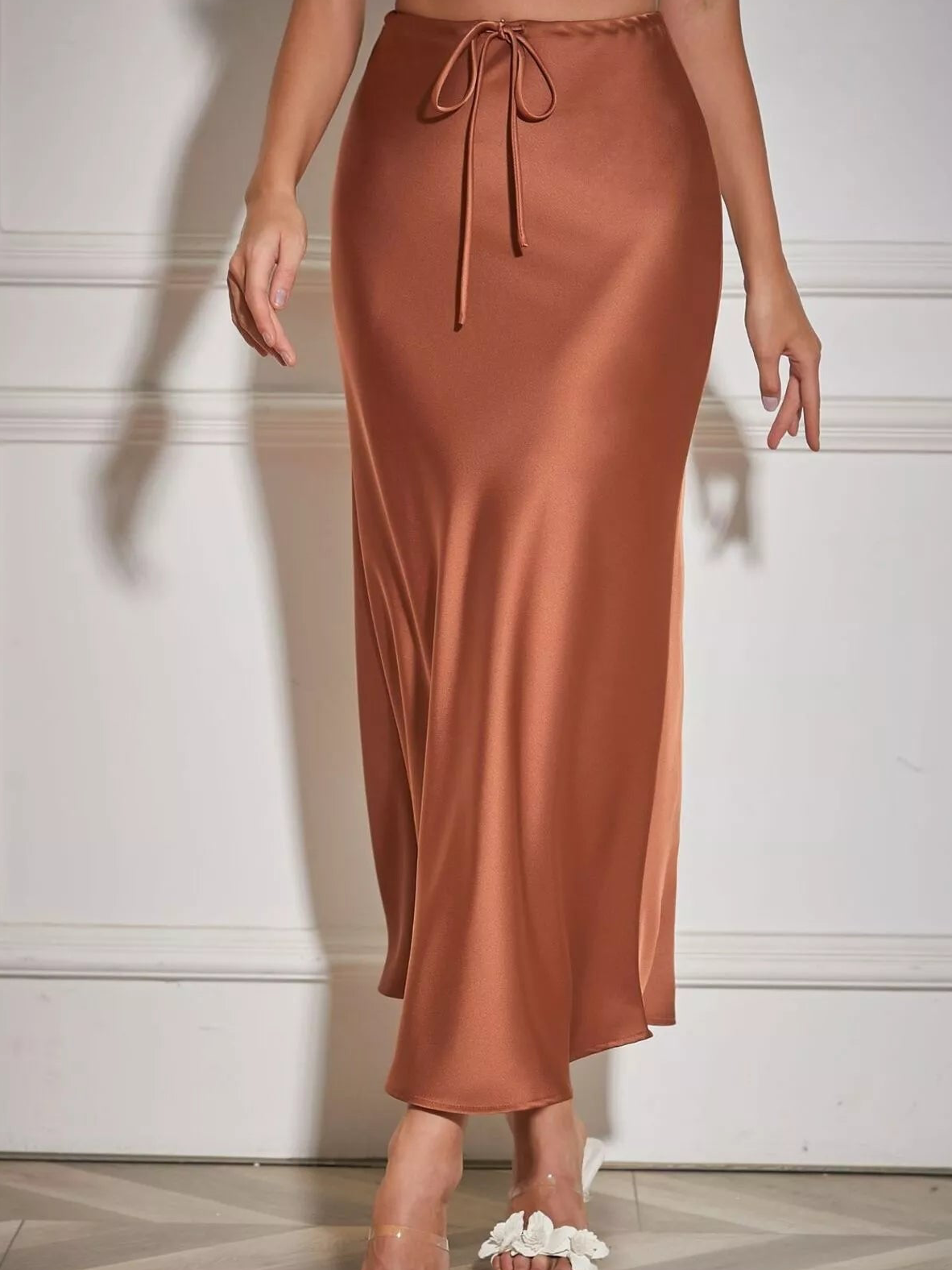 Brown satin midi skirt with a tie waist and slim, flowing silhouette