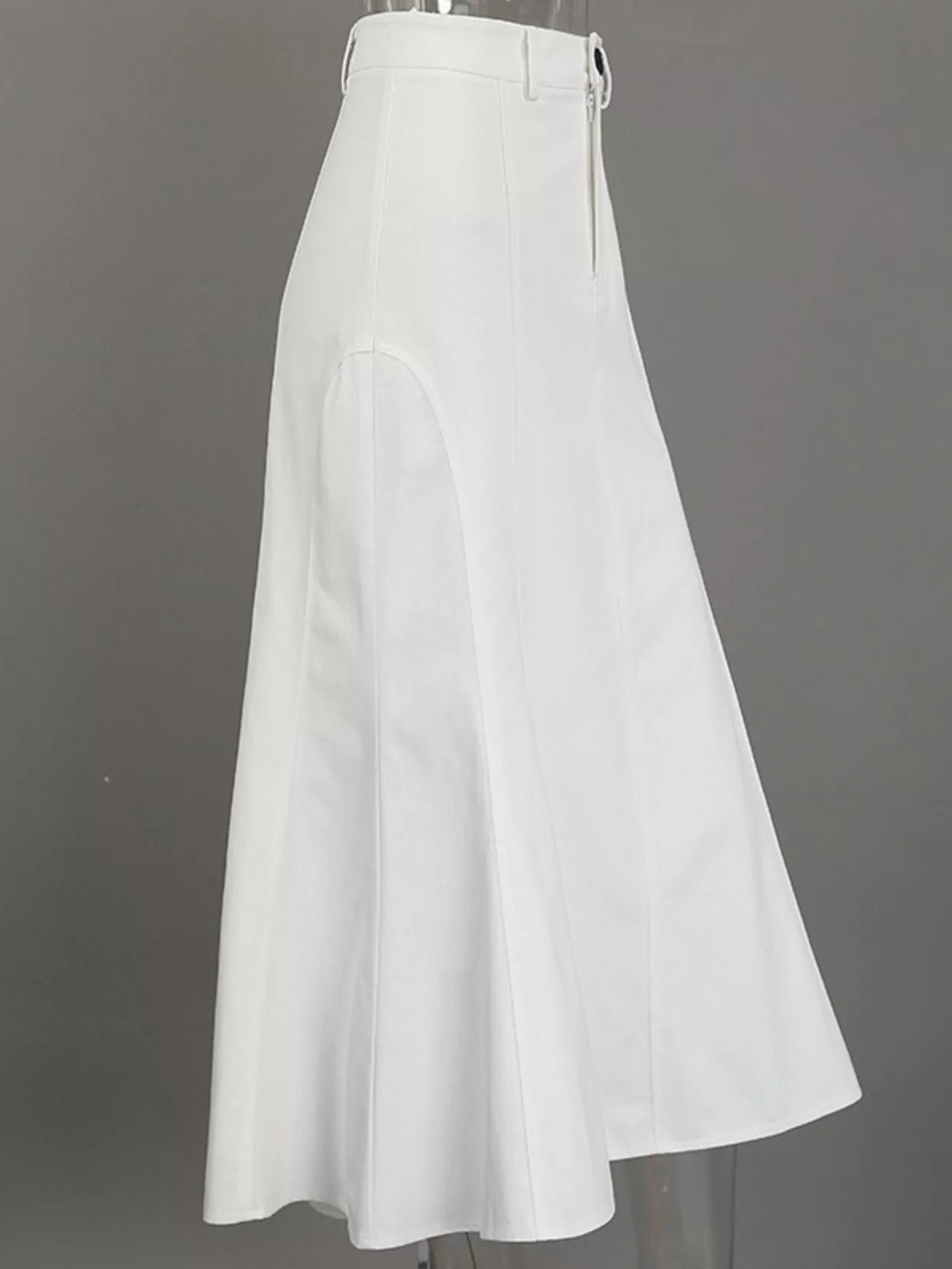 Side view of a white high-waisted mermaid midi skirt with curved panel seams