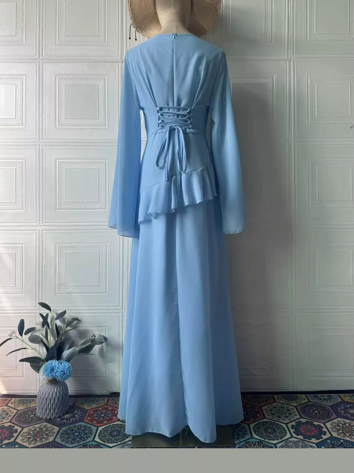 Light blue plus-size maxi dress with long sleeves and gathered back ruffle detail