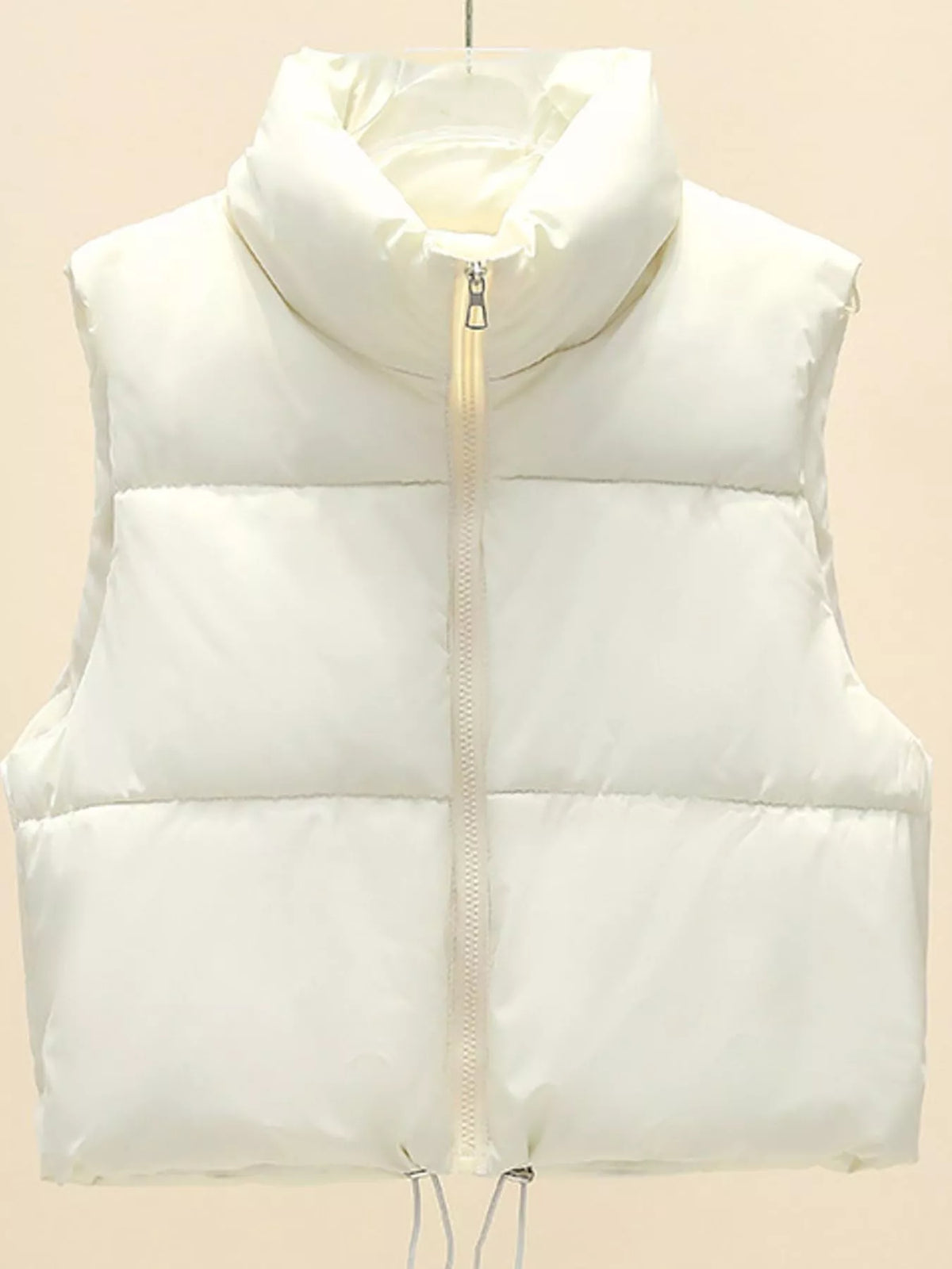 White zip-up puffer vest with stand collar and quilted front panels, sleeveless