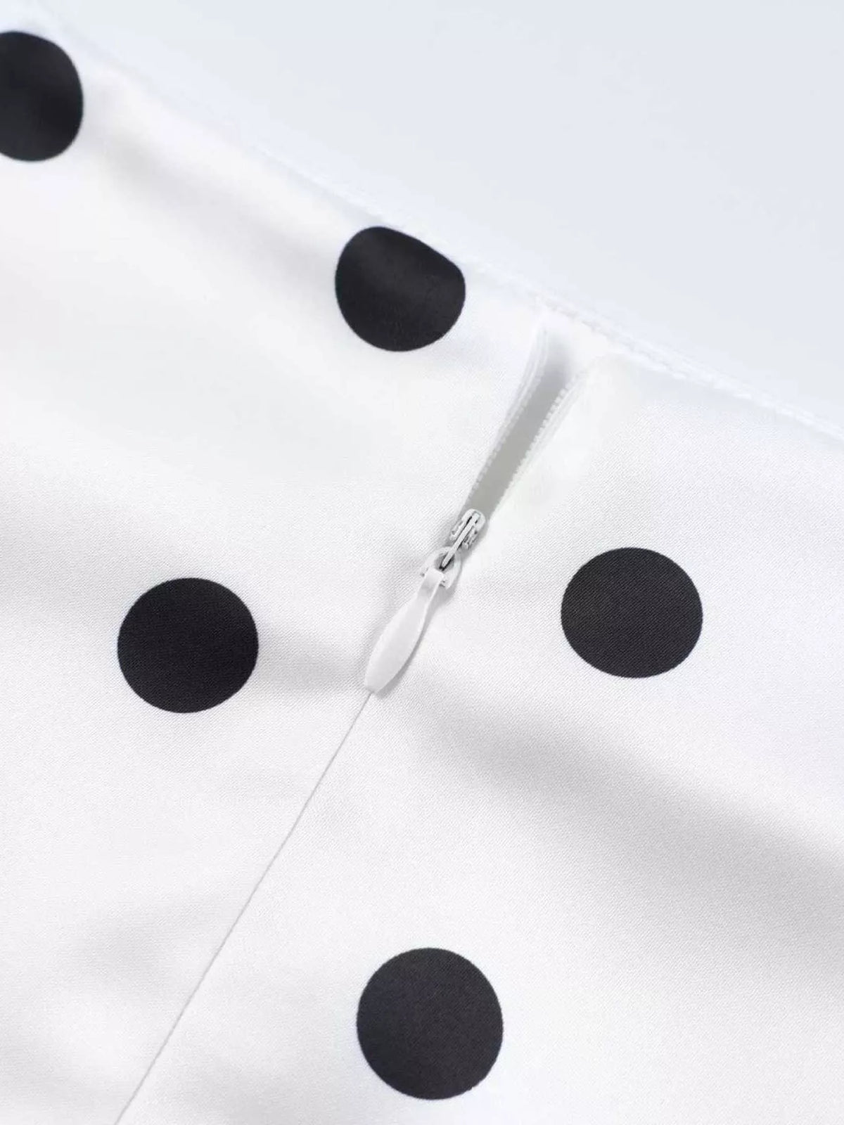 White polka dot midi skirt with a concealed side zipper