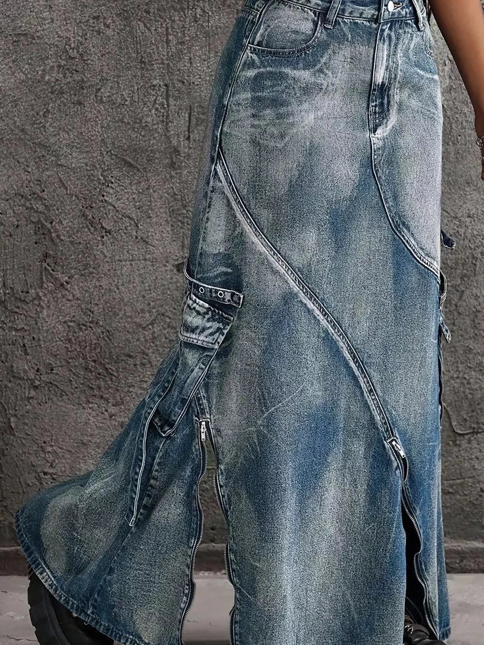 Blue high-waisted denim maxi skirt with diagonal patch pockets and front zipper slit