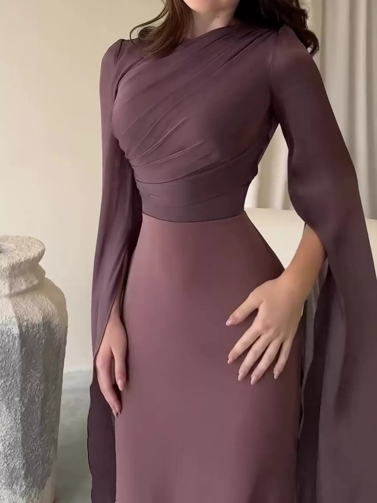 Mauve dress detail with diagonal bodice ruching and a fitted waist