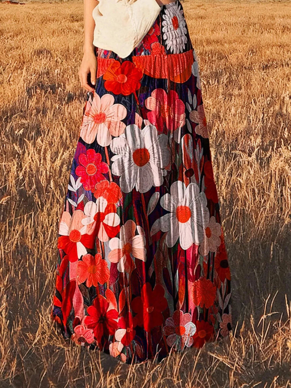 High-waisted maxi skirt with red and white flowers on dark fabric, tiered panels