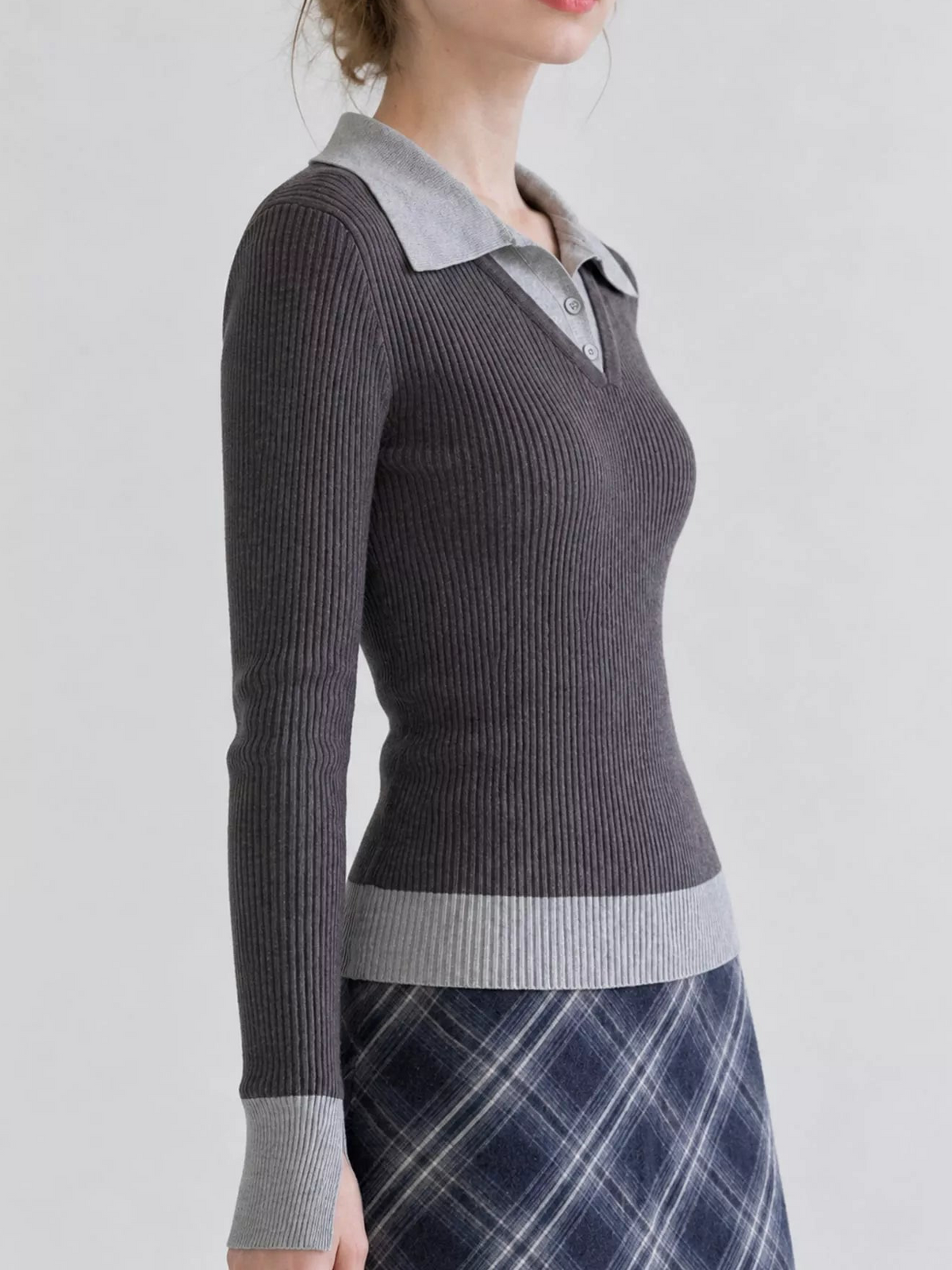 Charcoal ribbed knit top in side view, with gray collar, cuffs, and hem