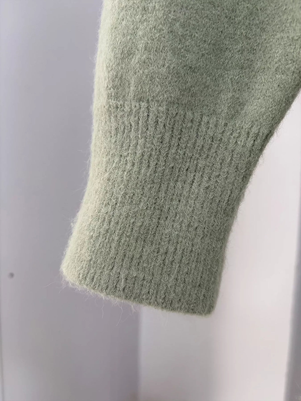 Close-up of the cardigan's ribbed knit sleeve cuff