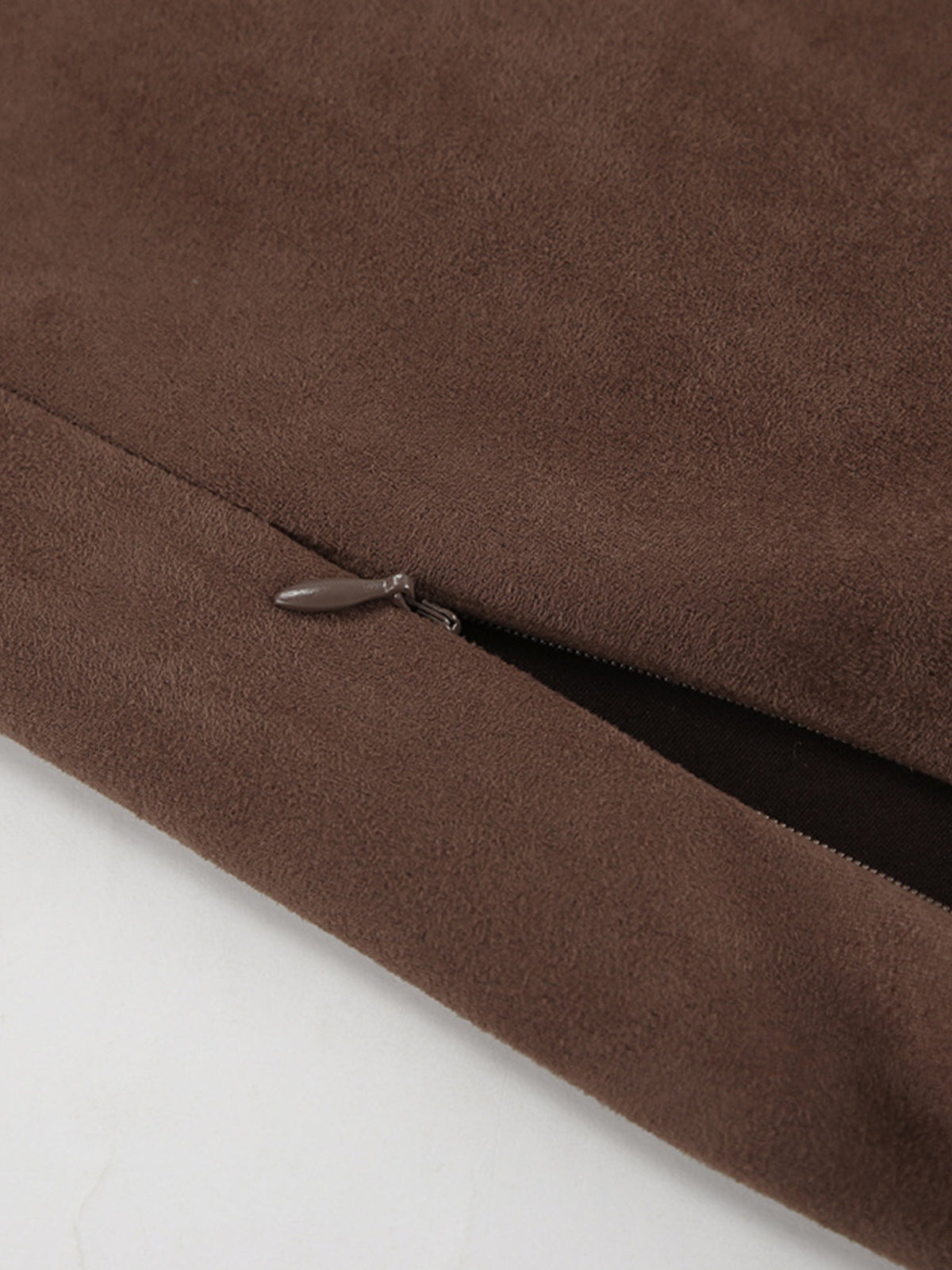 Close-up of the skirt's suede fabric and side zipper