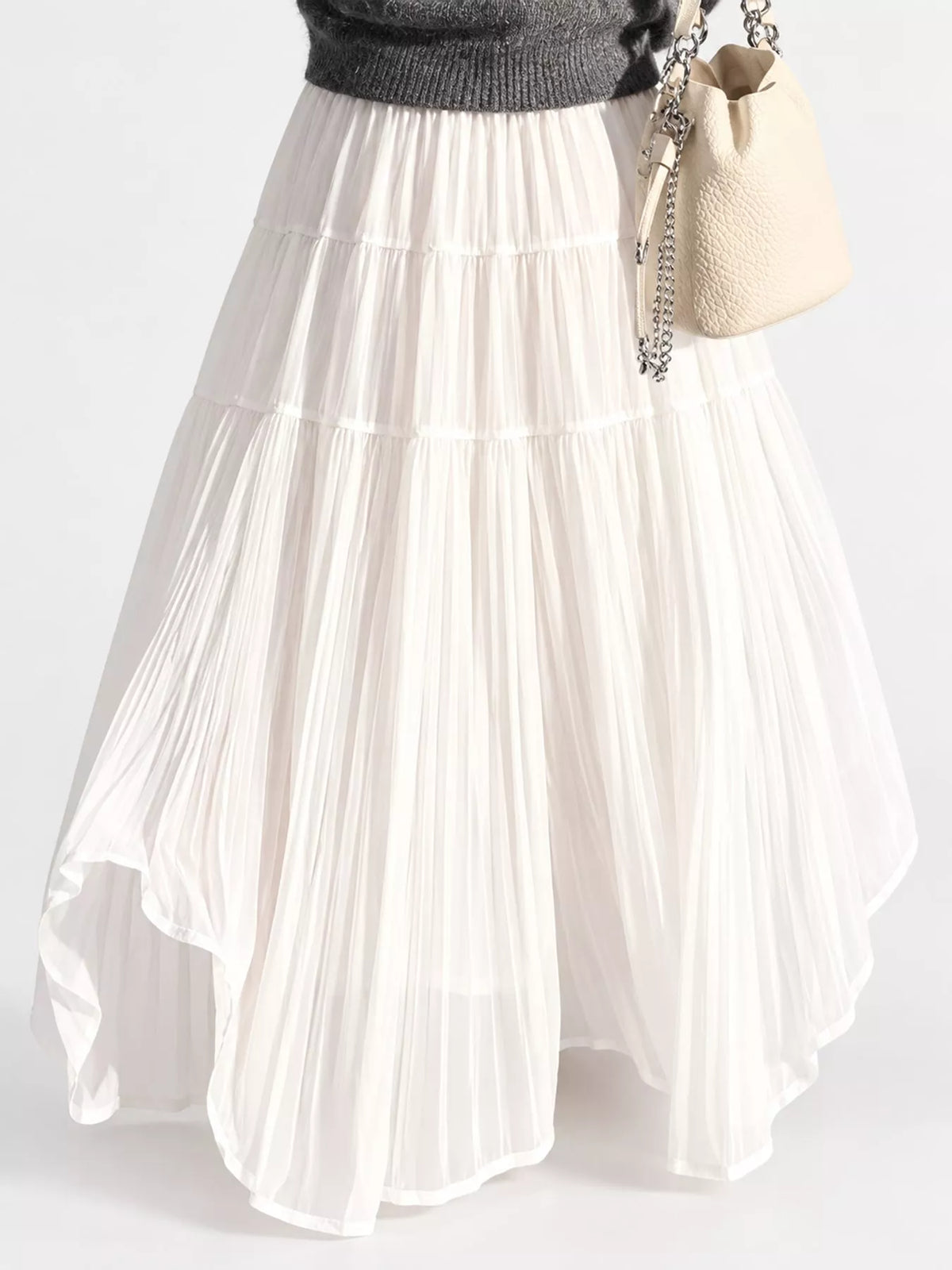 Cream tiered pleated maxi skirt with elastic waistband and softly layered tiers