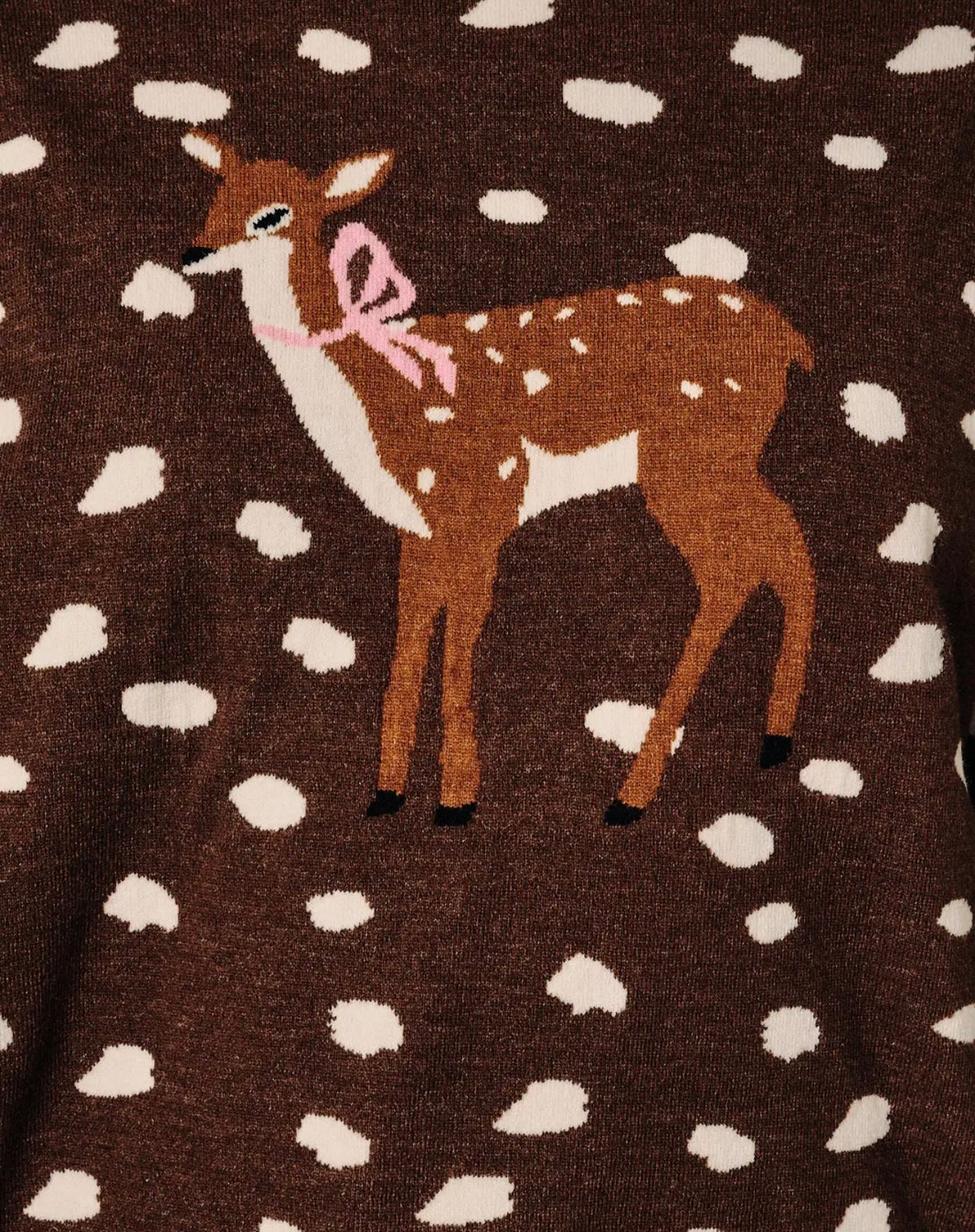 Close-up deer graphic on dark brown mock-neck knit sweater with white dot pattern