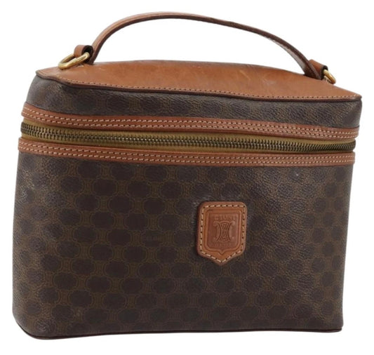 Brown patterned vanity hand bag with top handle, front leather badge, two zip rows
