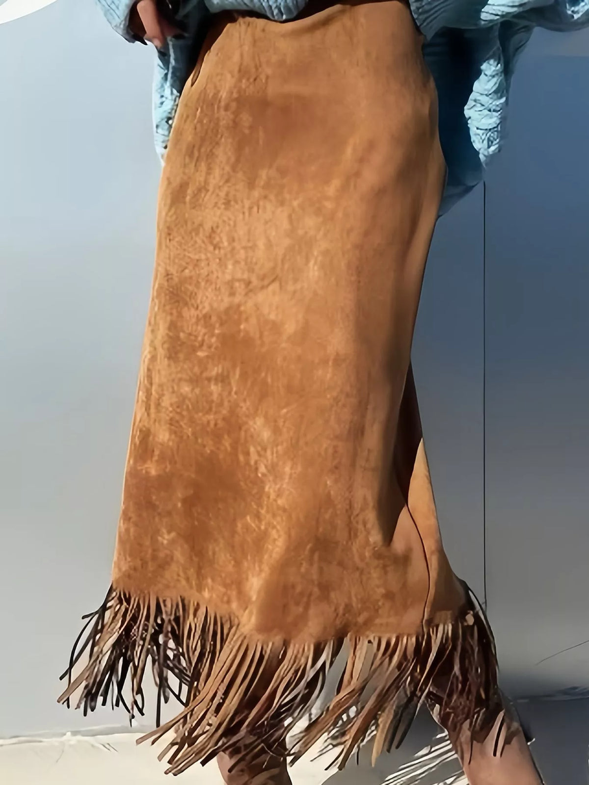 Light brown midi skirt with a high waist, side slit, and fringe trim