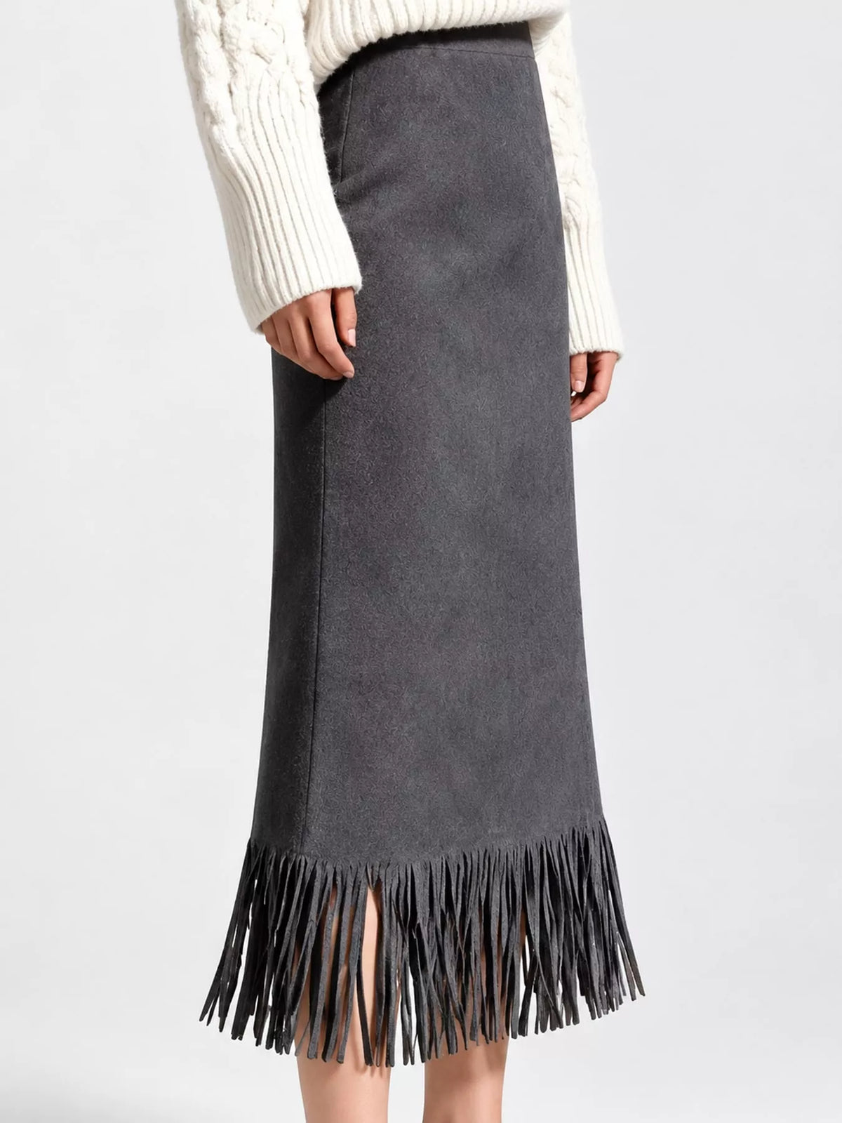 Side view of a dark gray midi skirt with long fringe at the hem