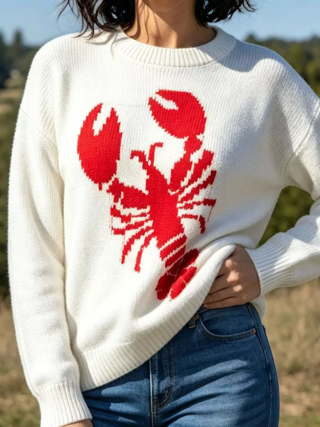 Ivory crew neck sweater featuring a red lobster graphic across the chest