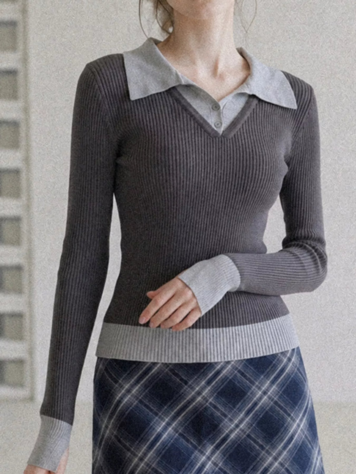 Charcoal ribbed knit top with gray collar and cuffs, shown with a button placket