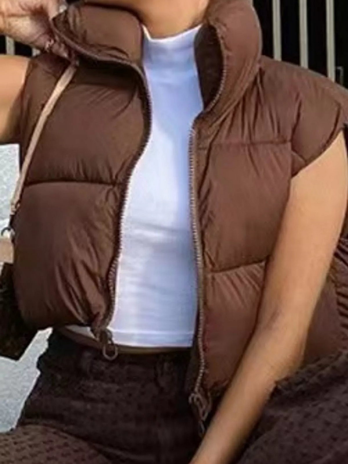 Coffee-brown zip-up puffer vest with stand collar and quilted front panels, sleeveless