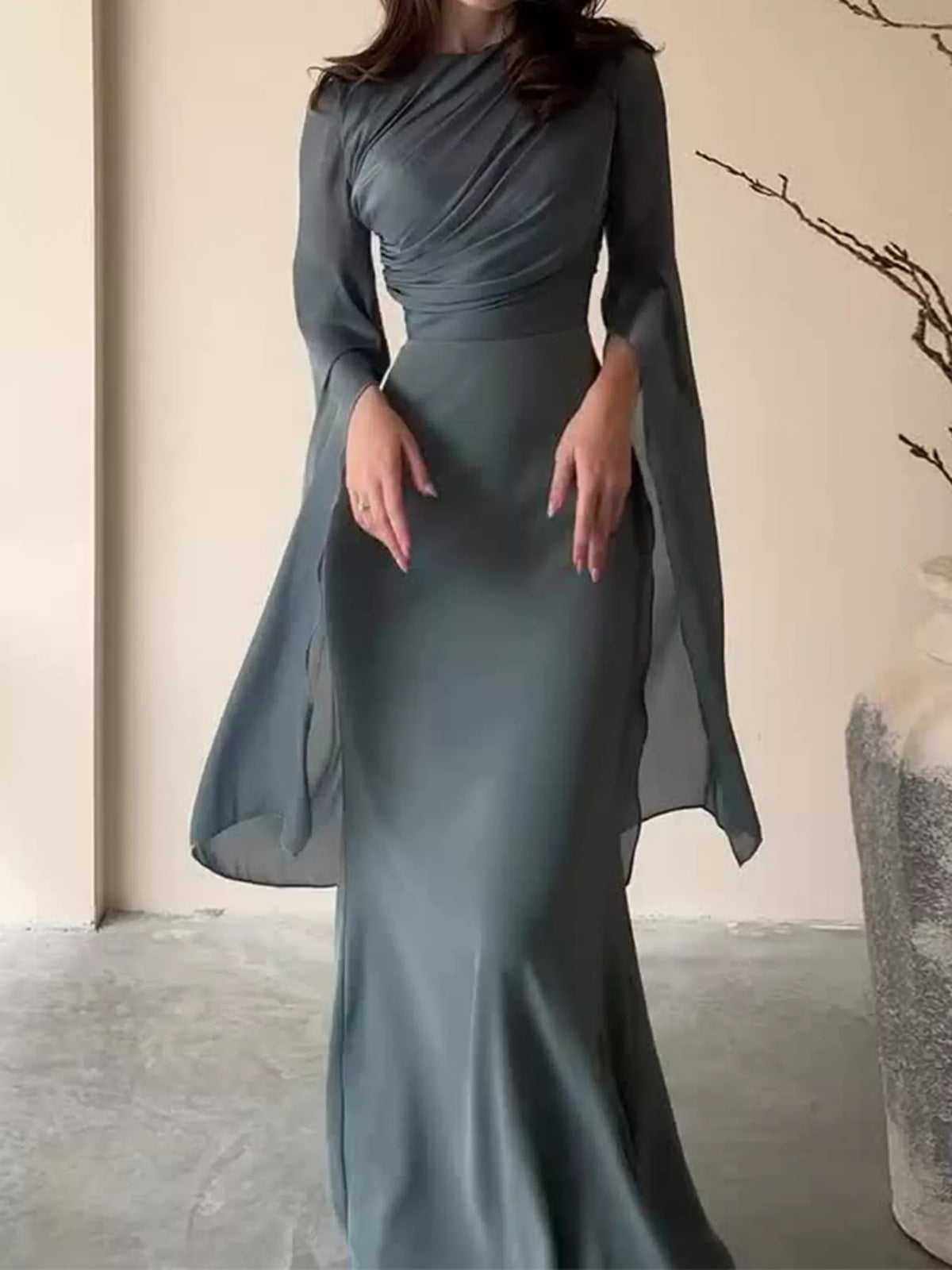 Dark gray maxi dress with a ruched bodice and long sheer sleeves