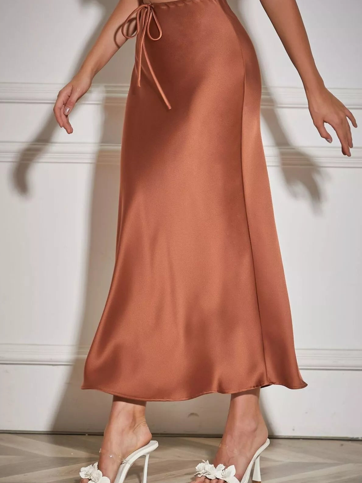 Brown satin midi skirt with a side-tied drawstring waist and flared hem