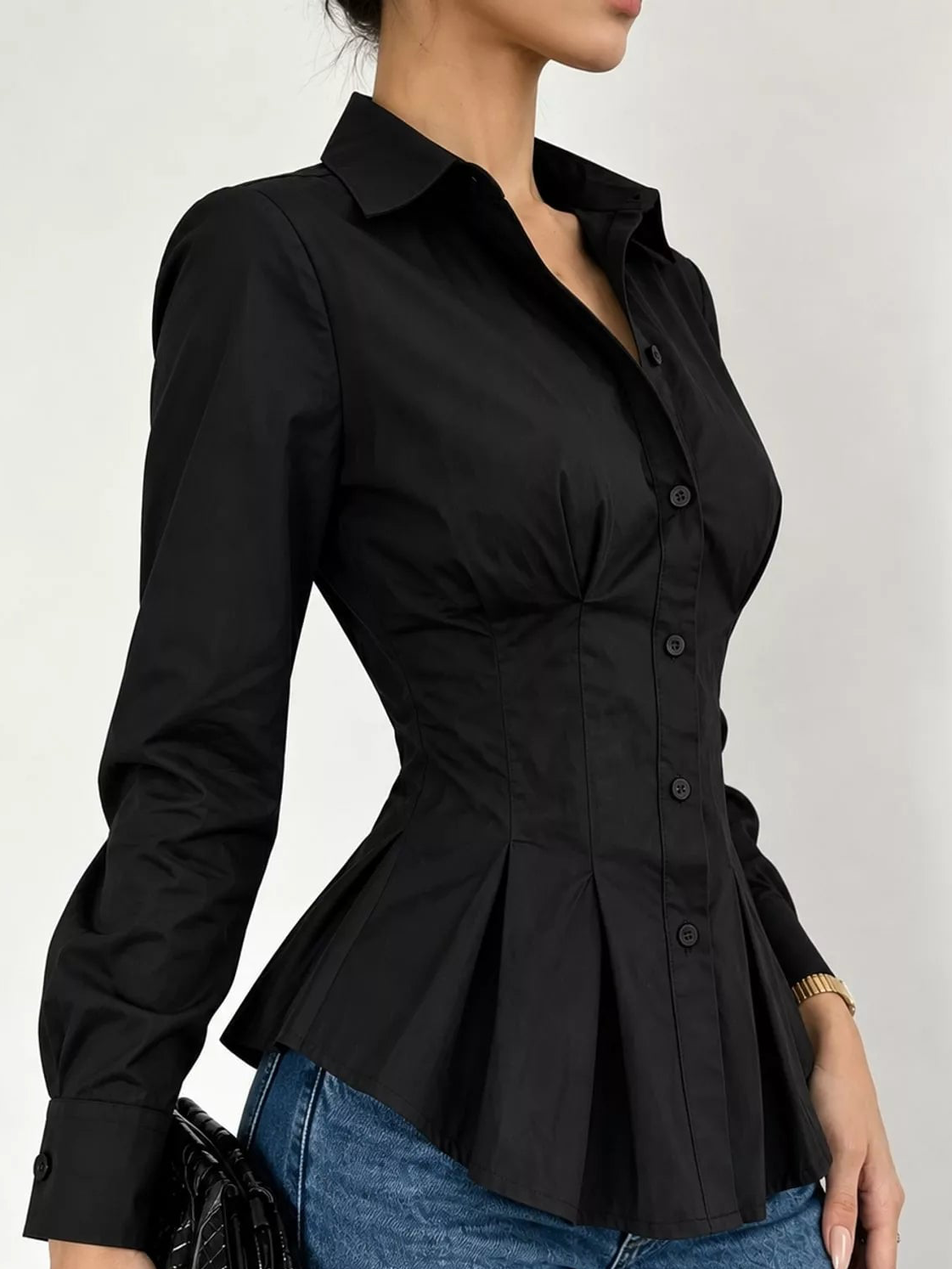 Black button-front peplum blouse with fitted waist and long sleeves, side view