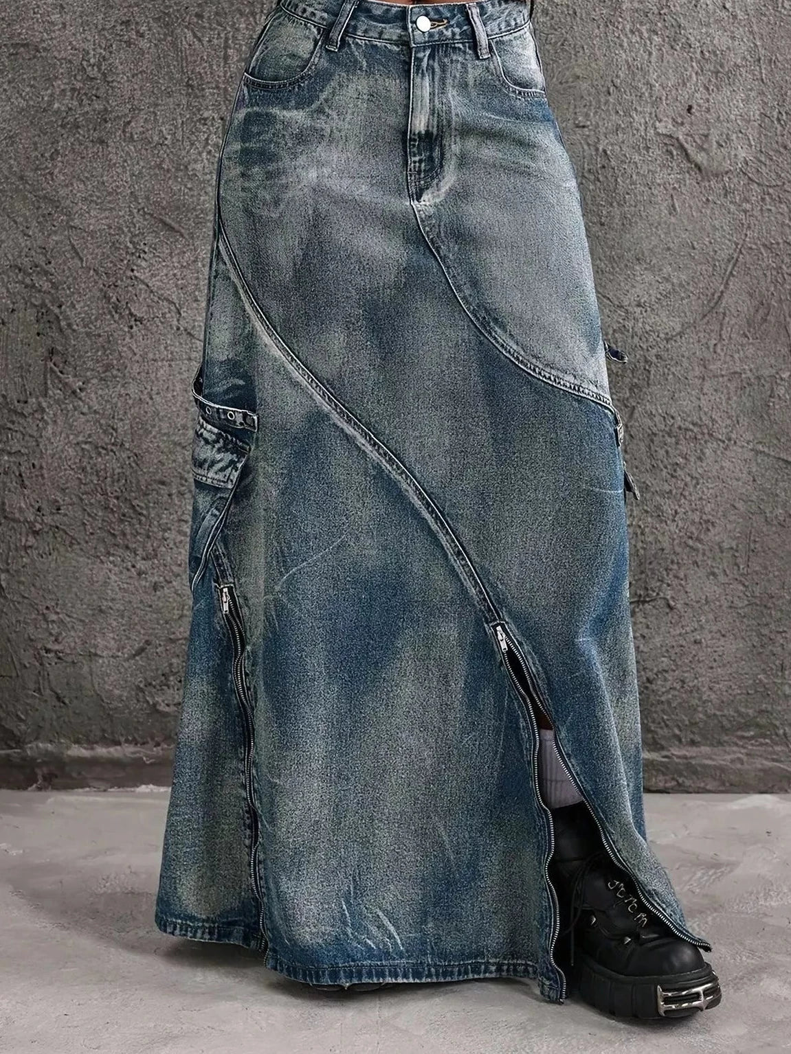 Blue high-waisted denim maxi skirt with asymmetrical seams and front zipper slit