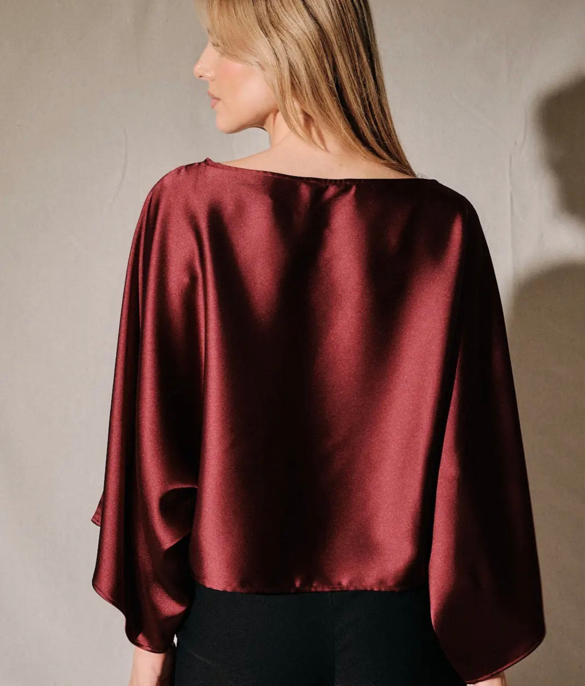 Burgundy satin boat-neck poncho top with loose dolman 3/4 sleeves, back side view