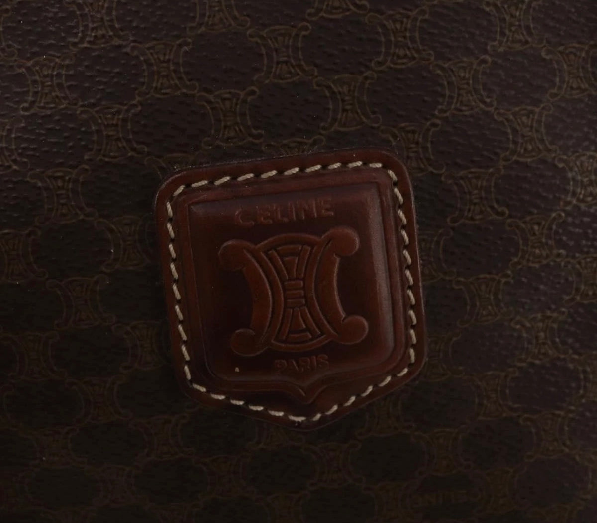 CELINE Macadam canvas Boston bag close-up of embossed leather logo plaque