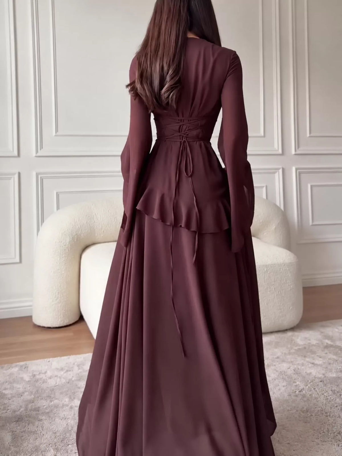 Plus size ruffled flare sleeve maxi dress in dark plum, back view with gathered waist