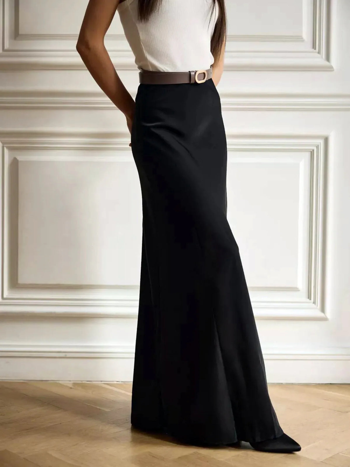 Black high-waisted maxi skirt with fitted waistband and flared maxi hem
