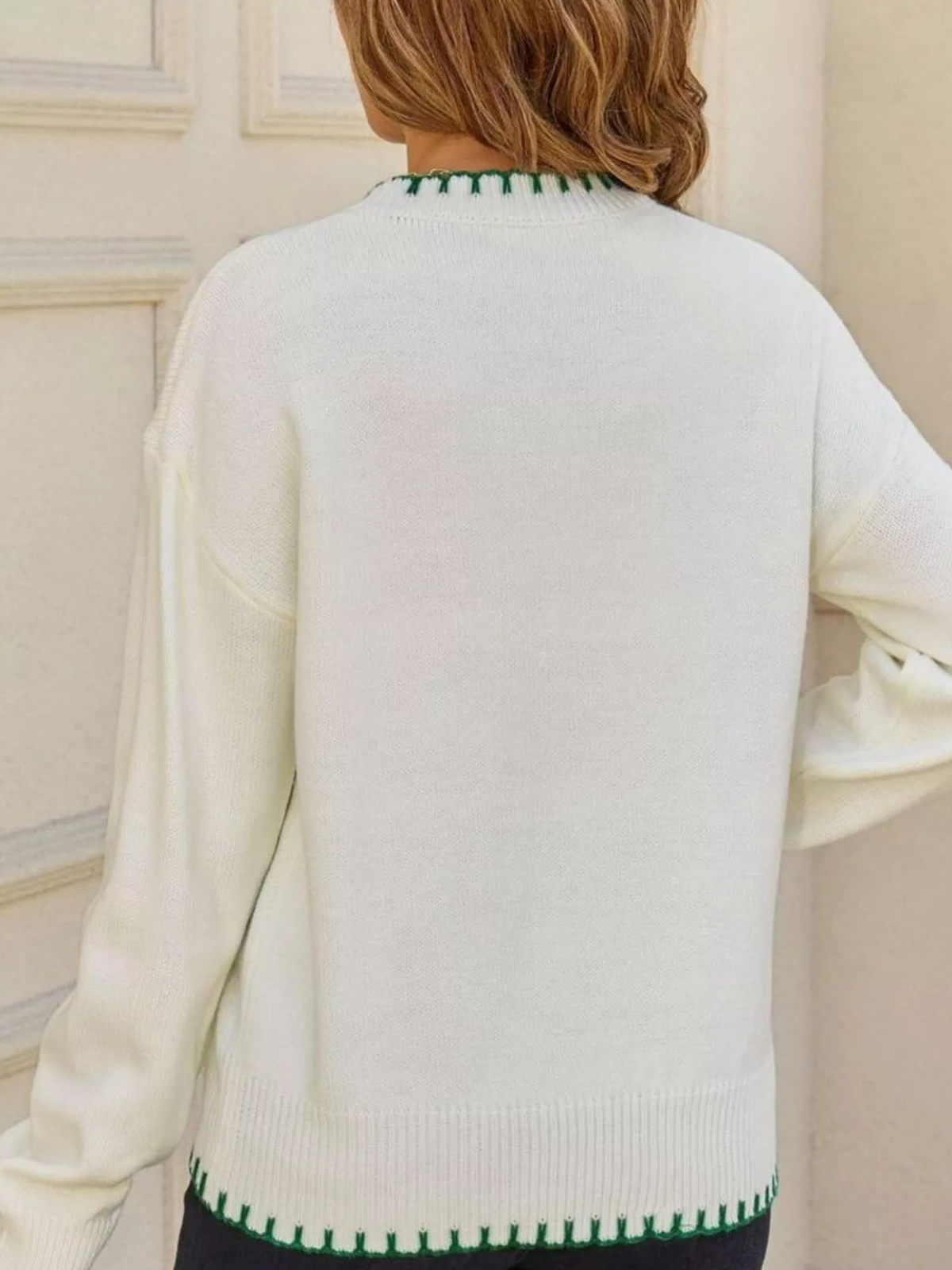 Cream back of round-neck sweater with green contrast ribbed hem and cuffs