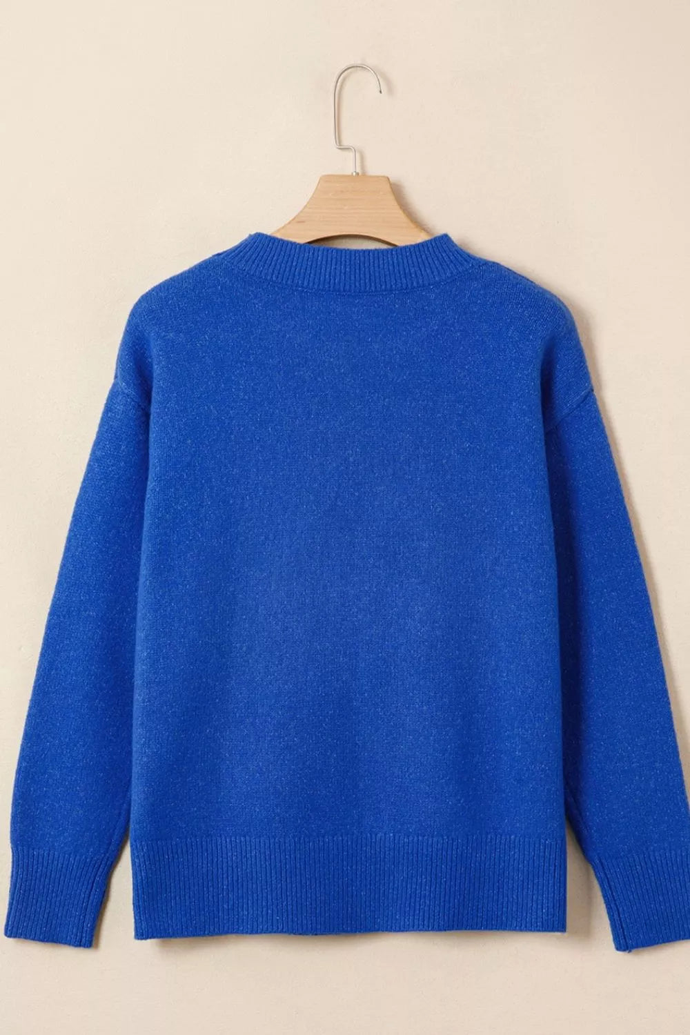 Royal blue knit sweater back view with crew neck ribbing and long sleeves