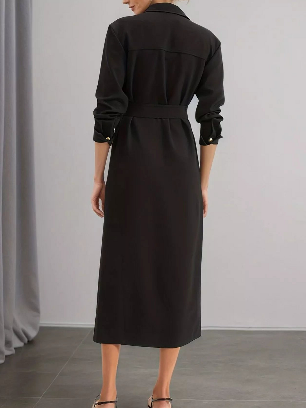 Black long sleeve midi dress back view with self-belt at waist and wide shoulder yoke